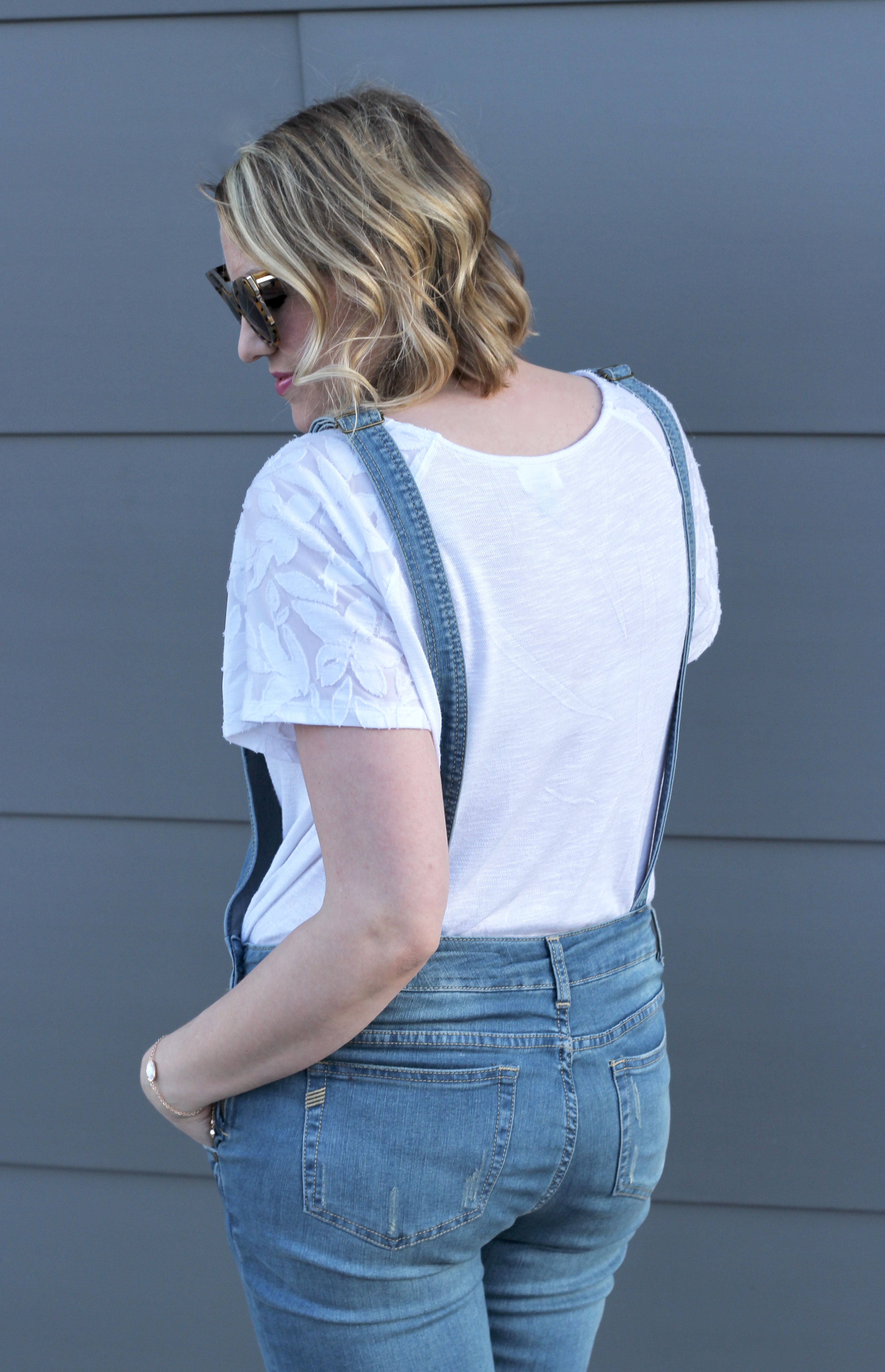 denim overalls outfit with a white flutter sleeve top