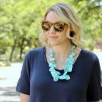 navy dress and a turquoise statement necklace