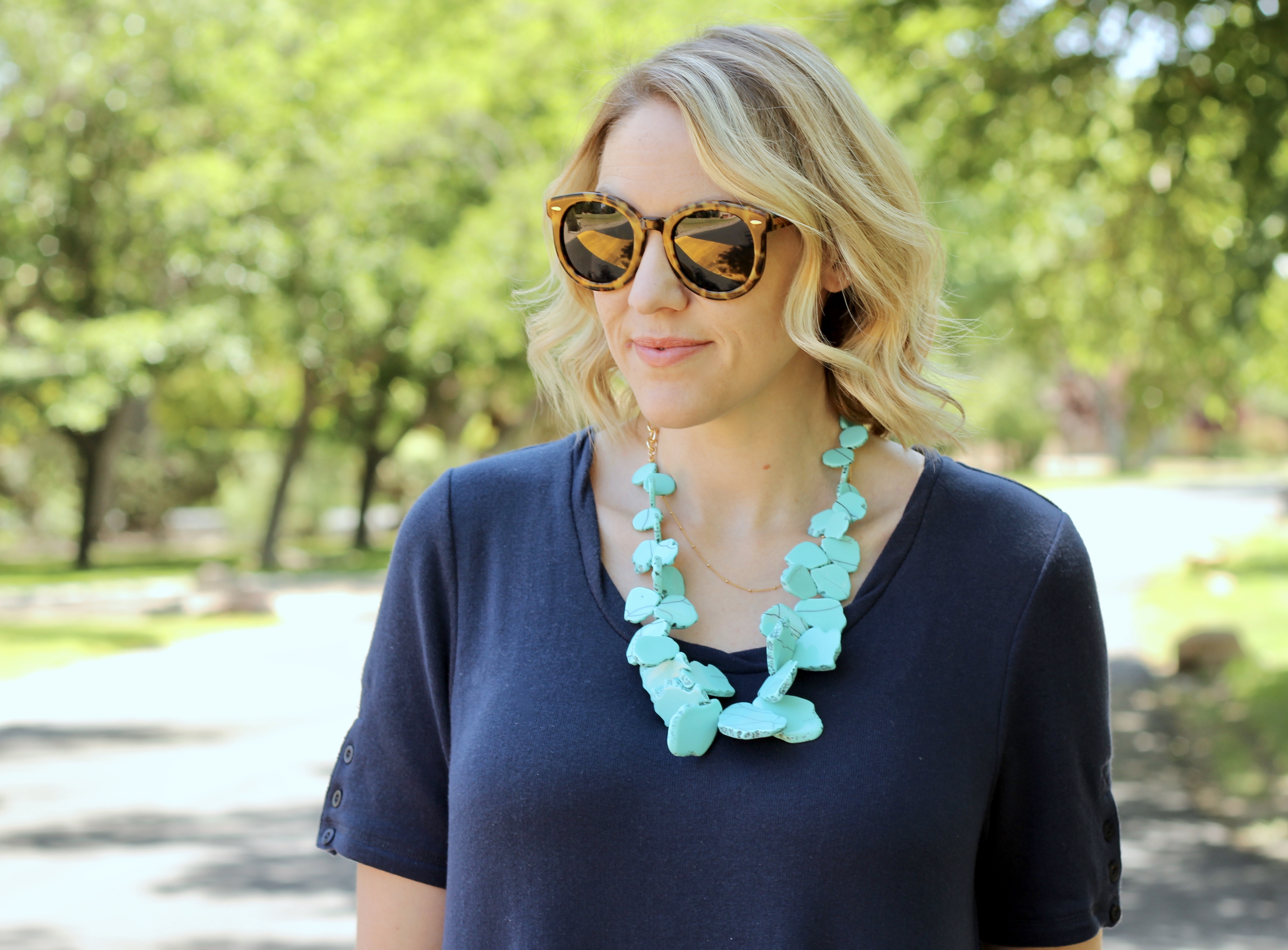 navy dress and a turquoise statement necklace 