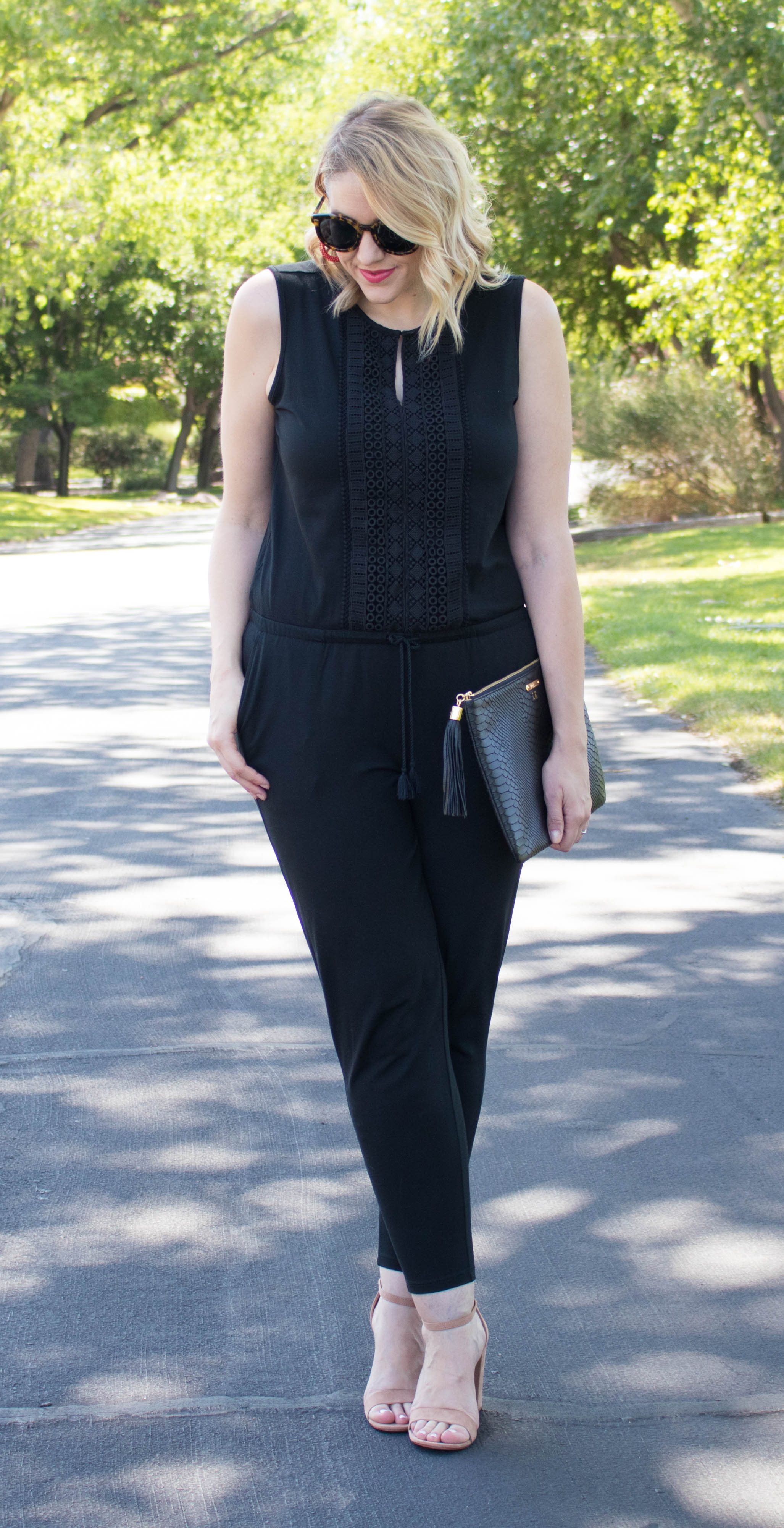 Meghan Markles gold earrings and black jumpsuit and pumps