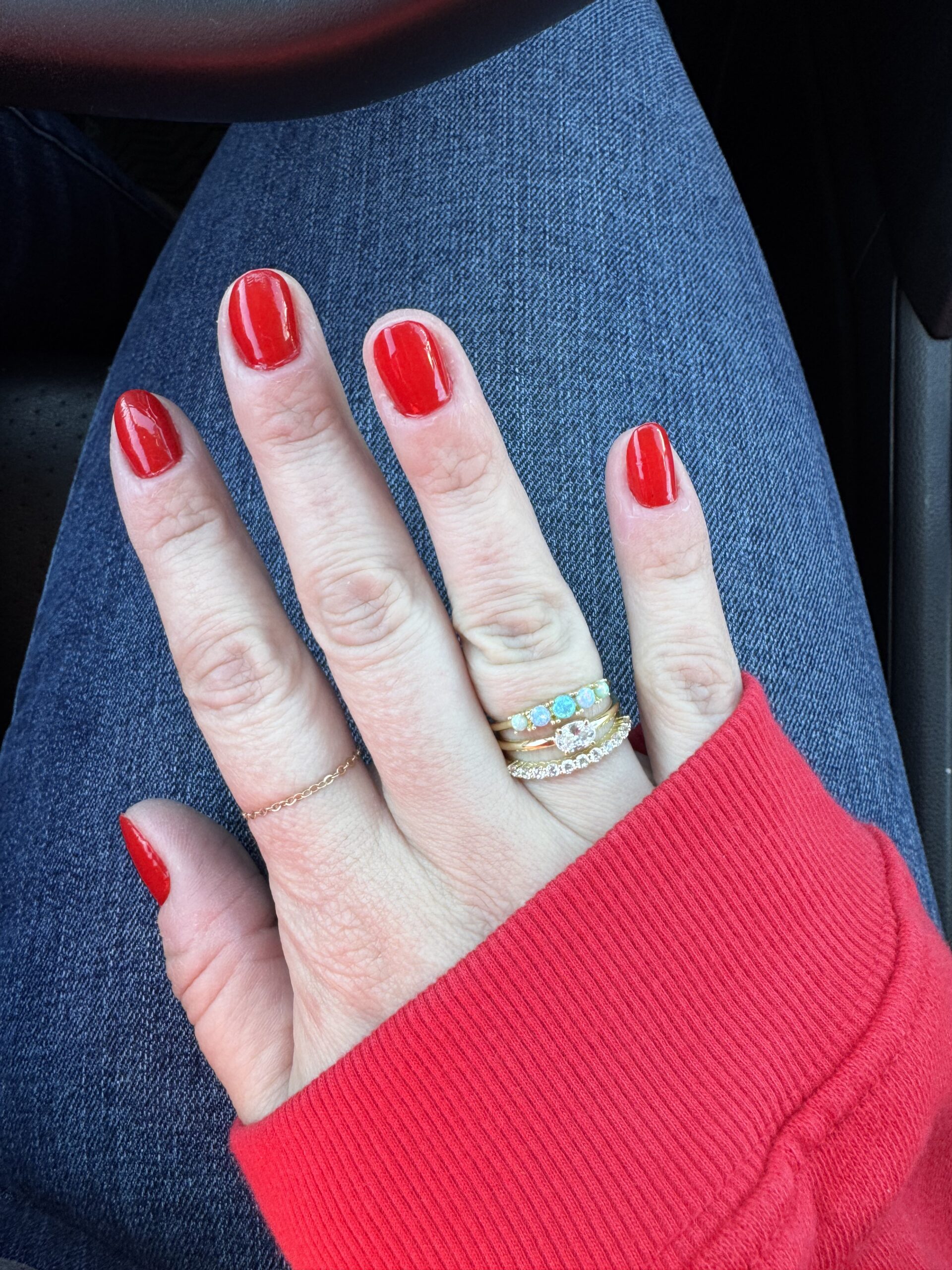 gold rings and red nail polish olive and june